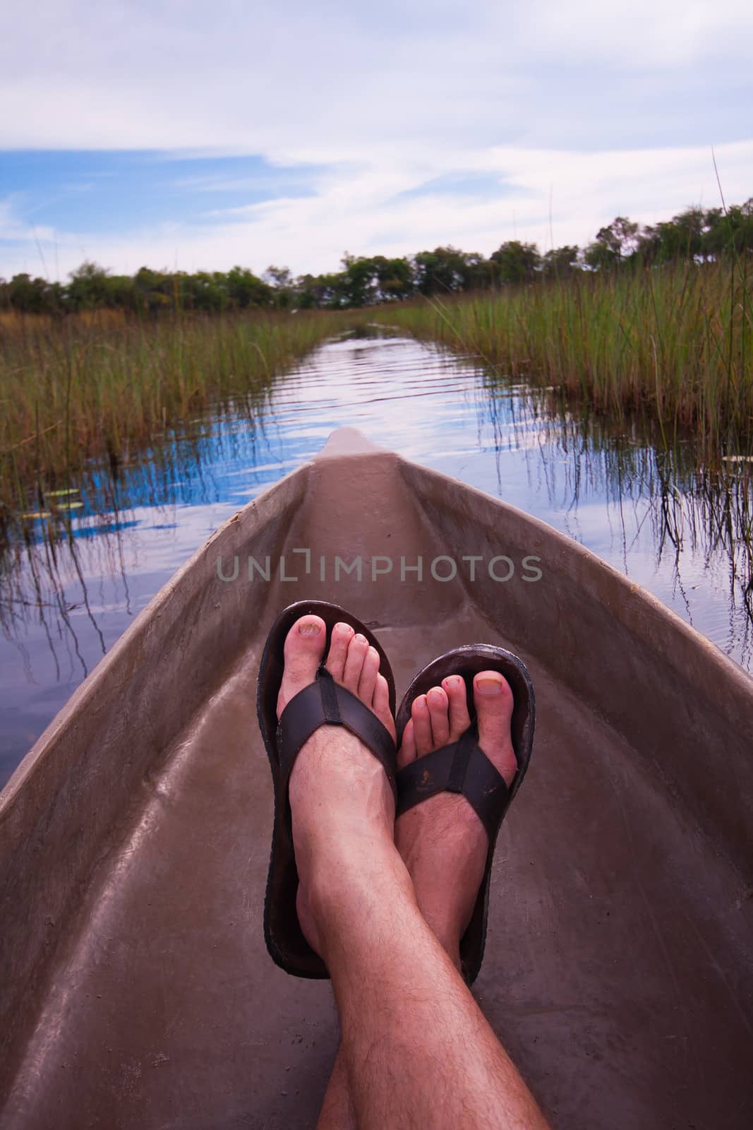 mans feet relaxing a canoe with an interesting point of view