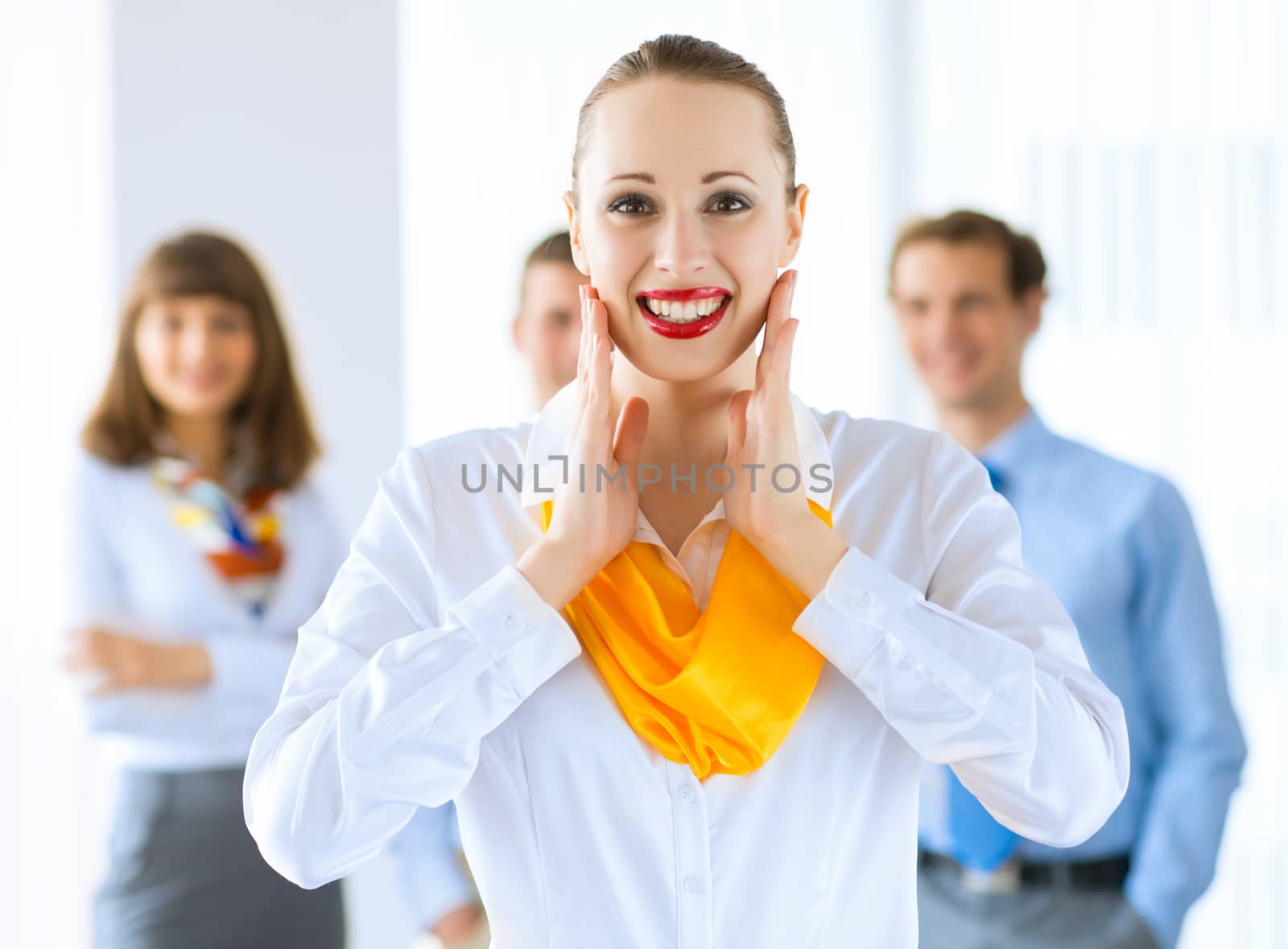 Portrait of a young successful business woman standing against colleagues