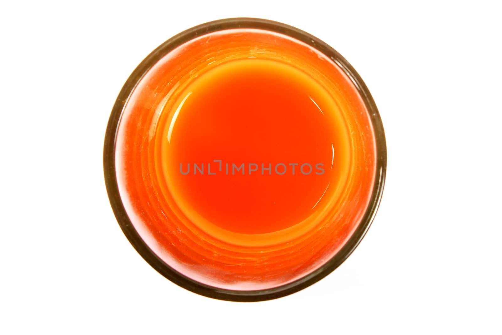 orange colorful liquid in glass isolated over white