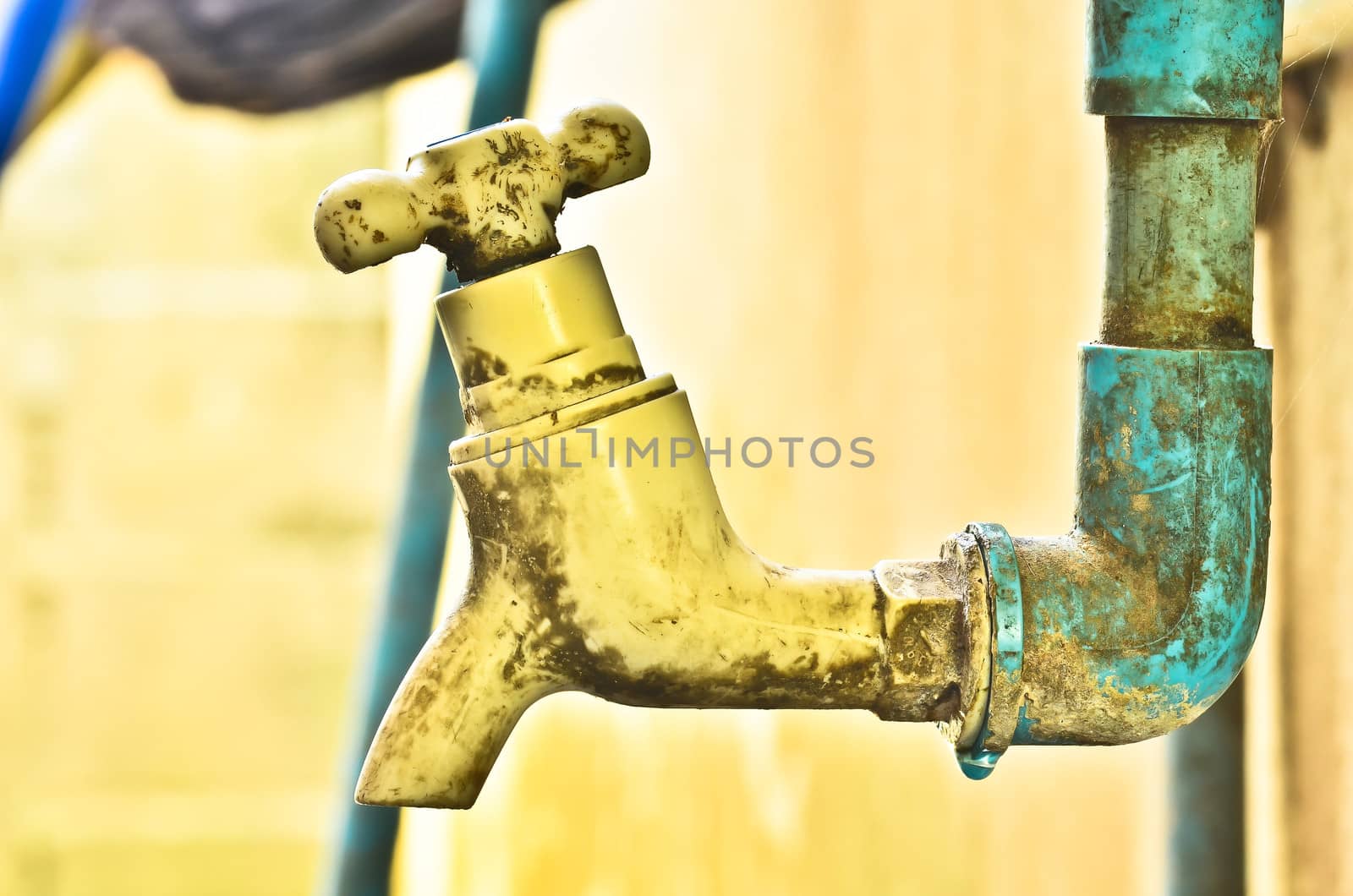 old rusty tap leaking water by raweenuttapong