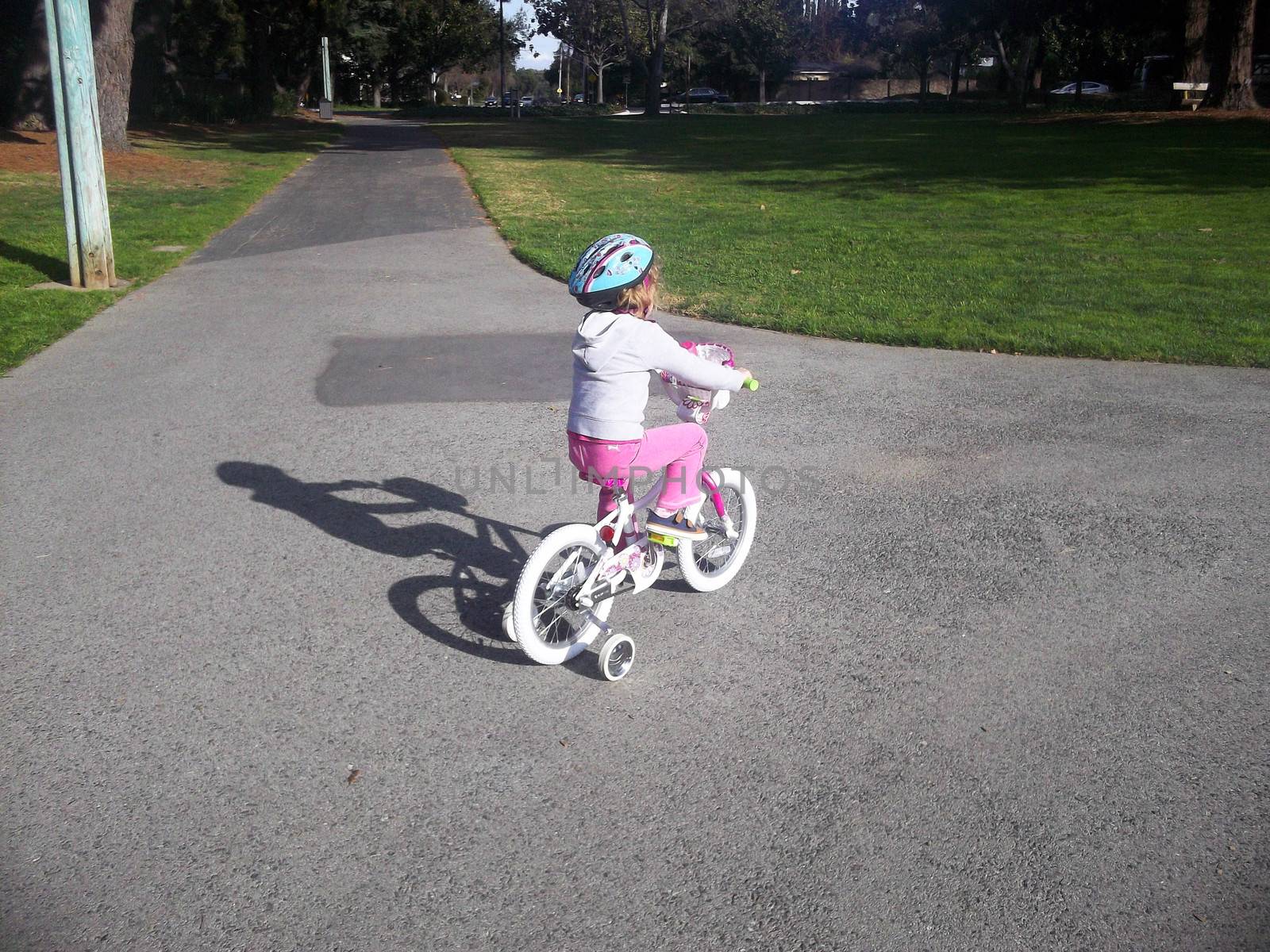 Trying new bicycle for first time on a ride in a park.