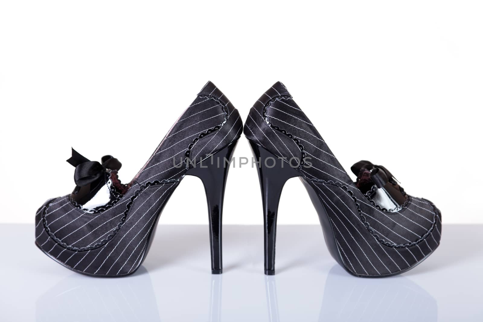 Gangster style female shoes, studio shot on white background 