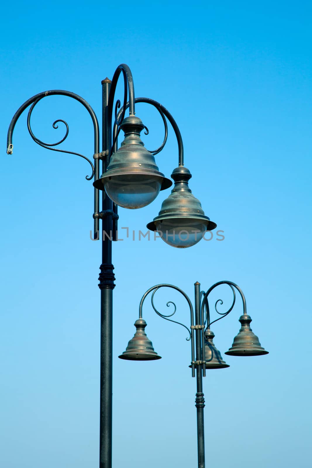 old street-lamp on blue sky