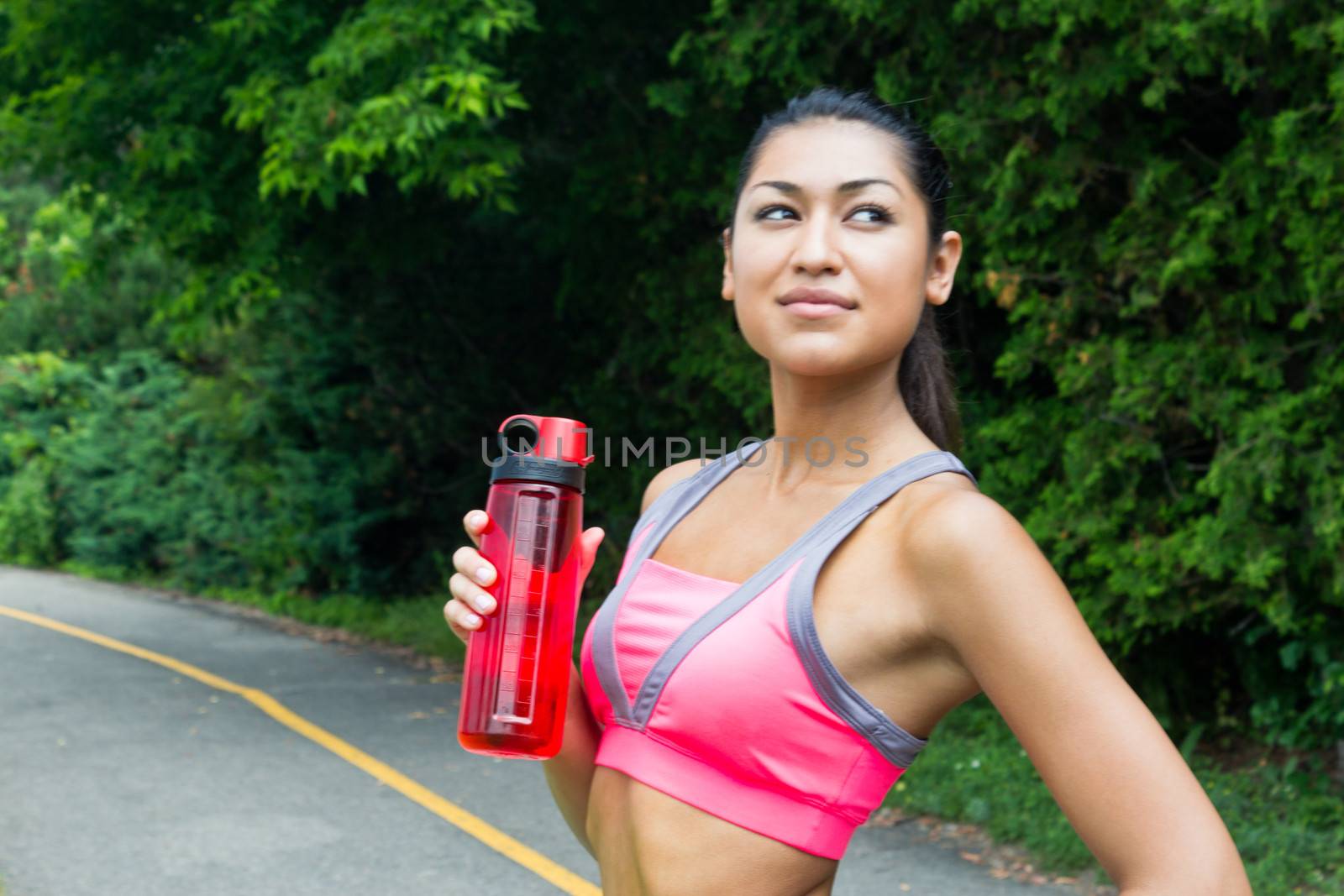 Fit young woman with water bottle after running