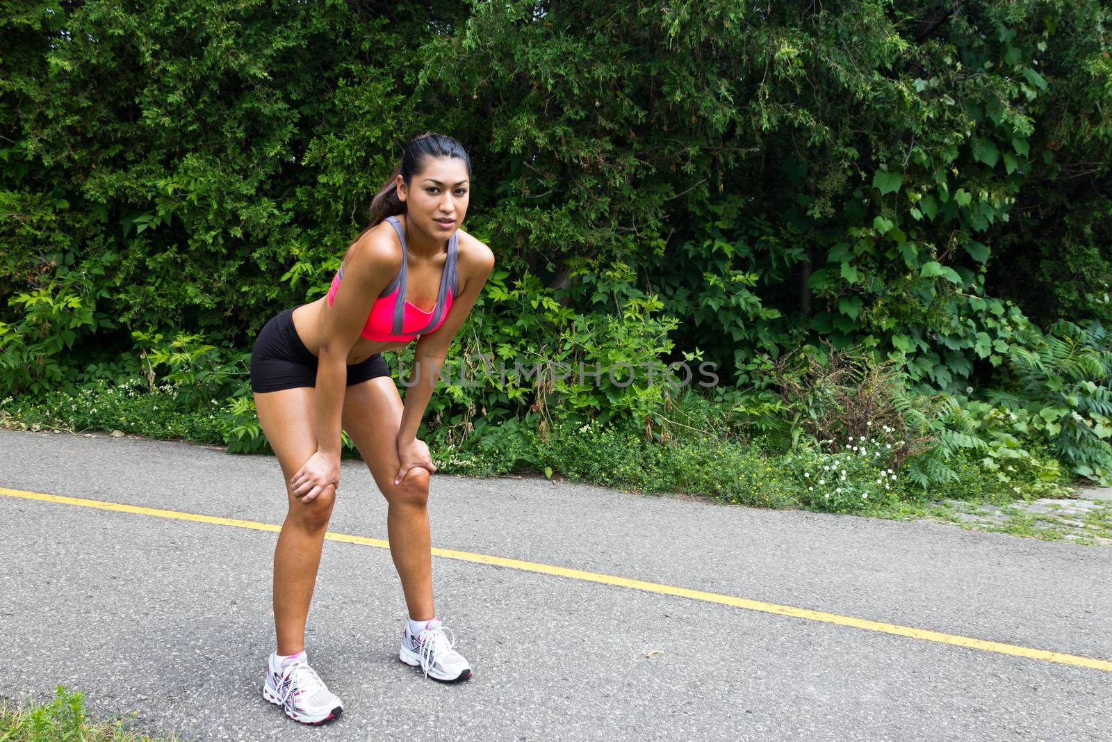 Young woman exhausted after running