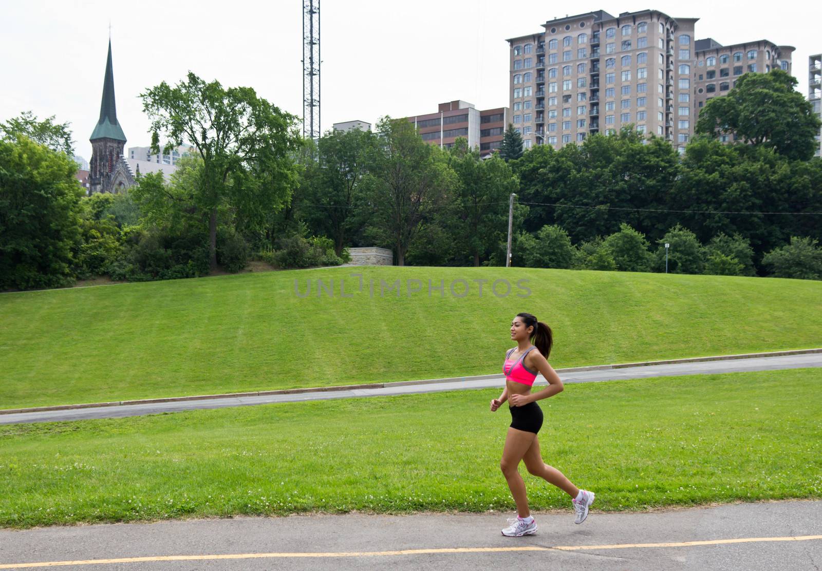 Fit woman running in the city park