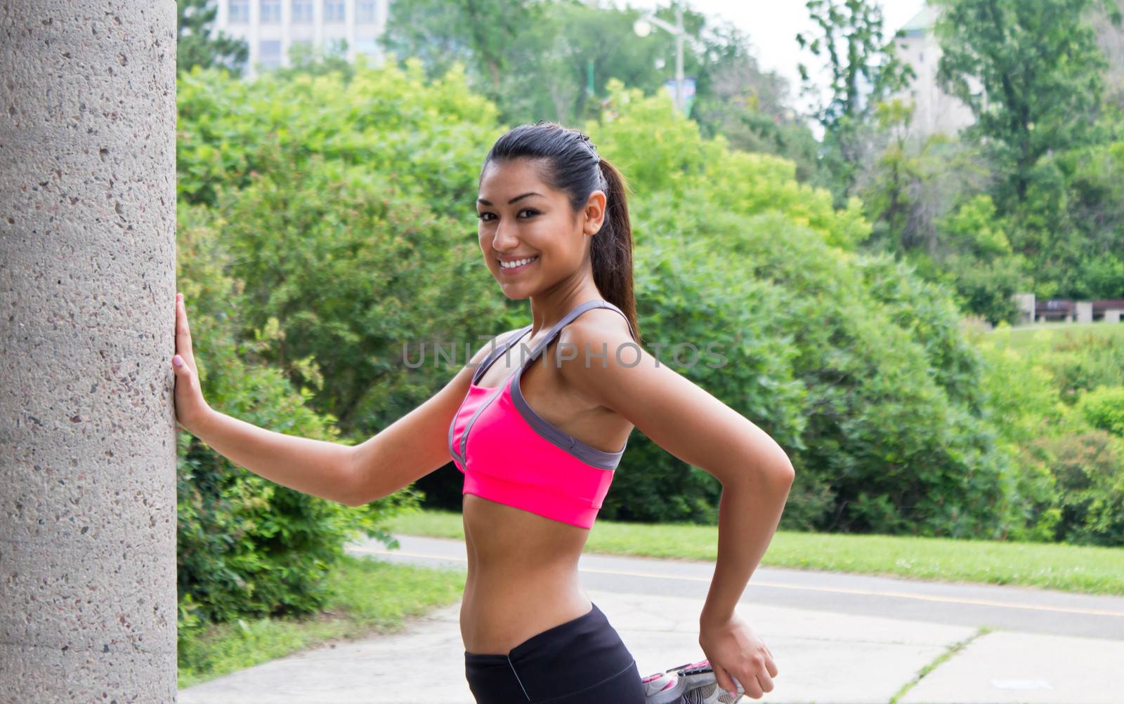 Young woman stretches before running