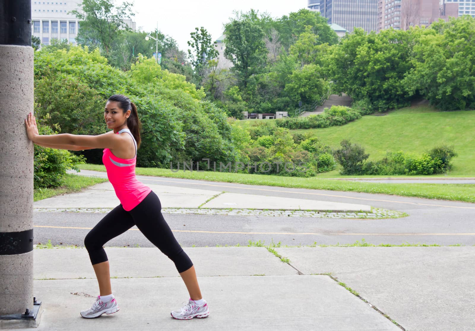 Young woman stretches before running