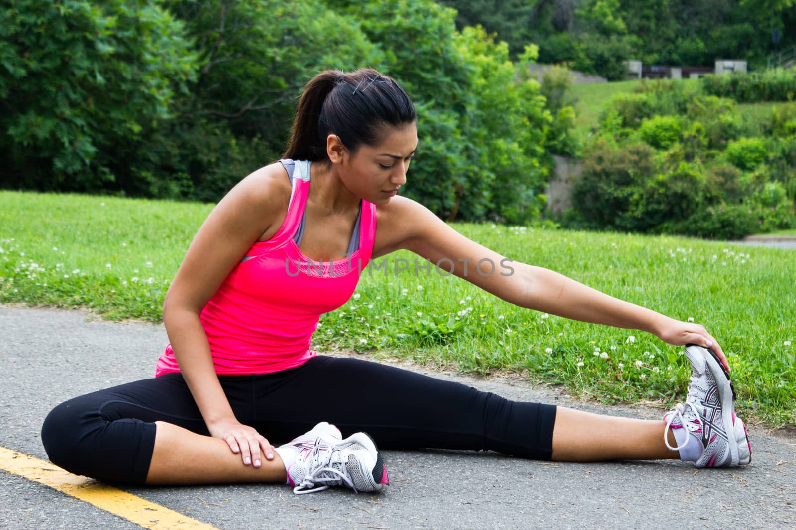 Young woman stretches before running