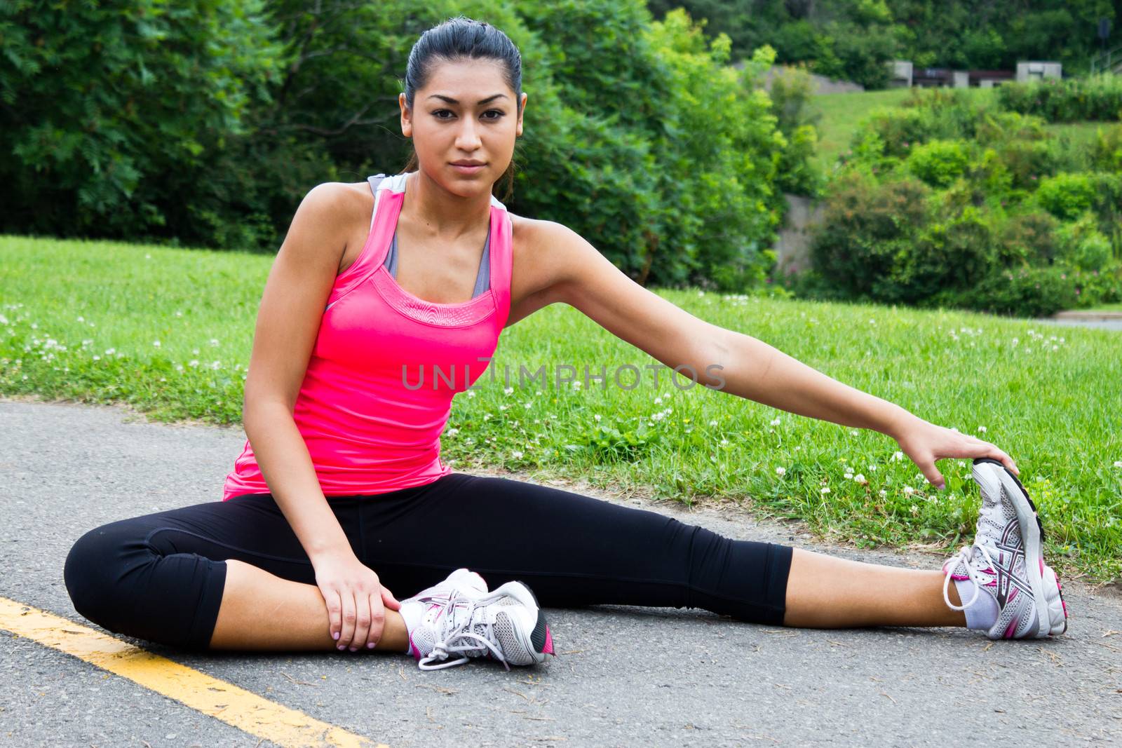 Young woman stretches before jogging