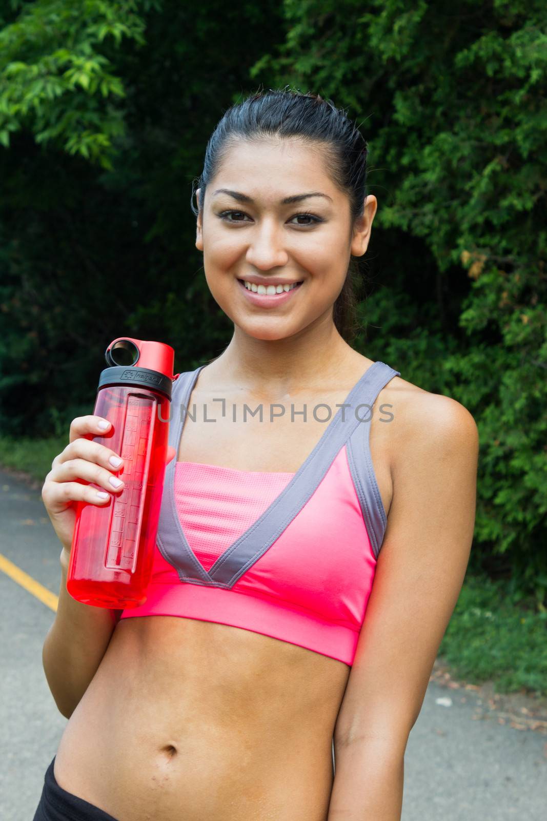 Fit young woman with water bottle after running