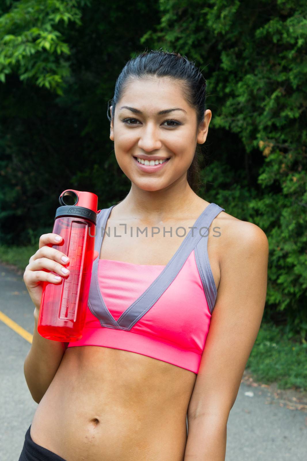 Fit young woman with water bottle after running