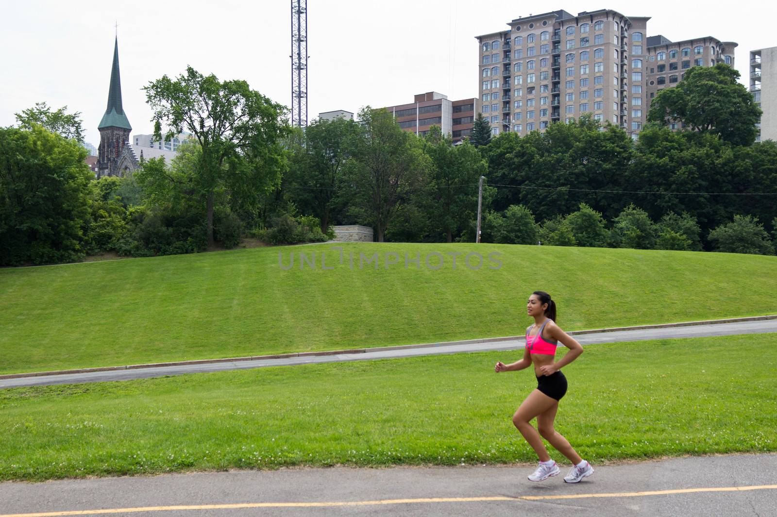 Fit woman running in the city park