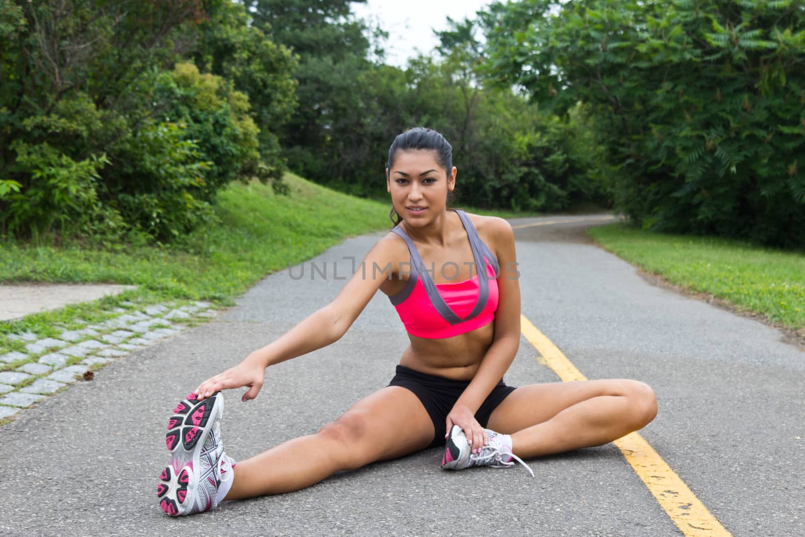 Young woman stretches before running