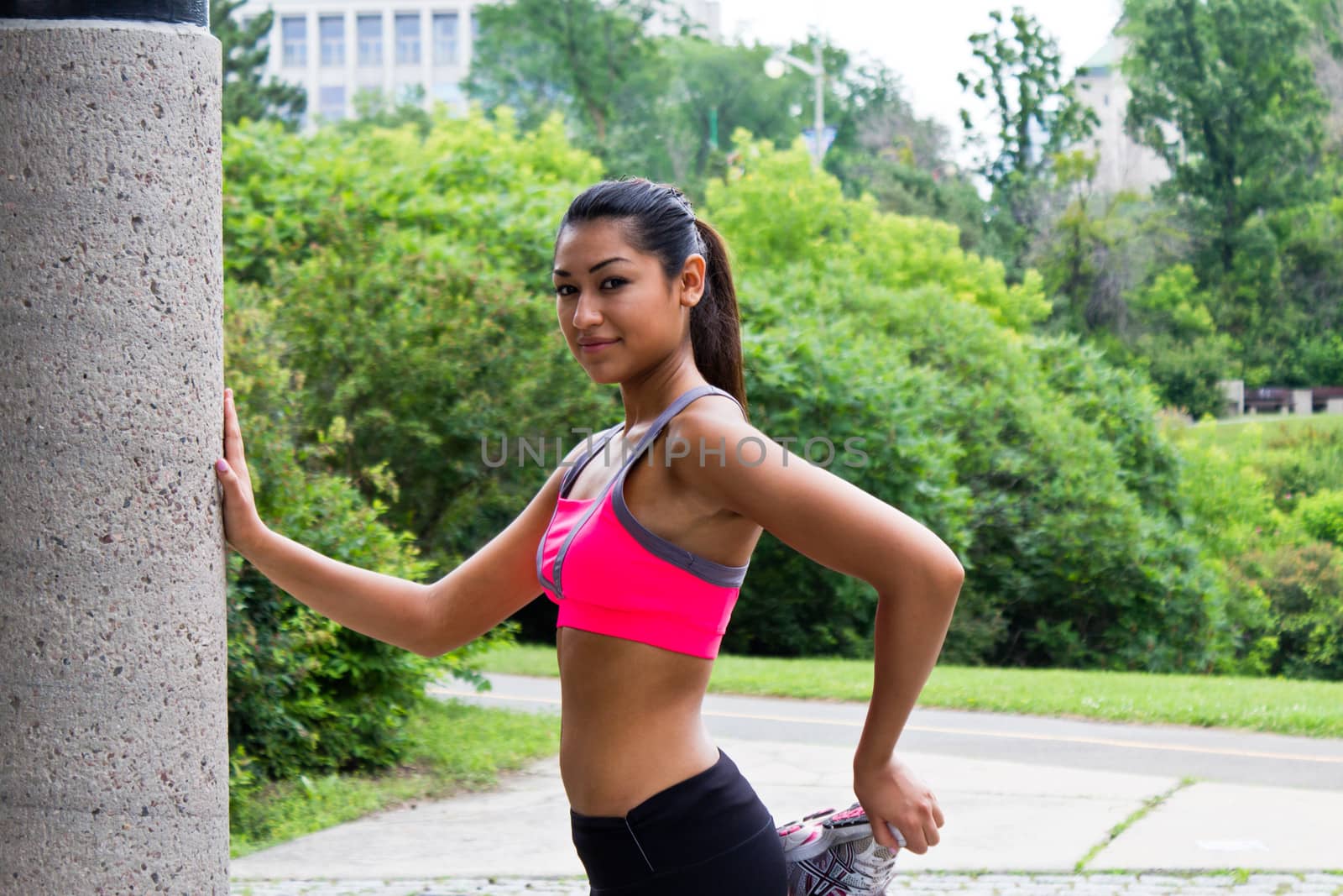 Young woman stretches before running