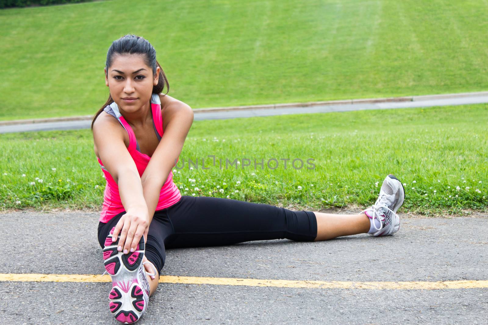 Young woman stretches before jogging