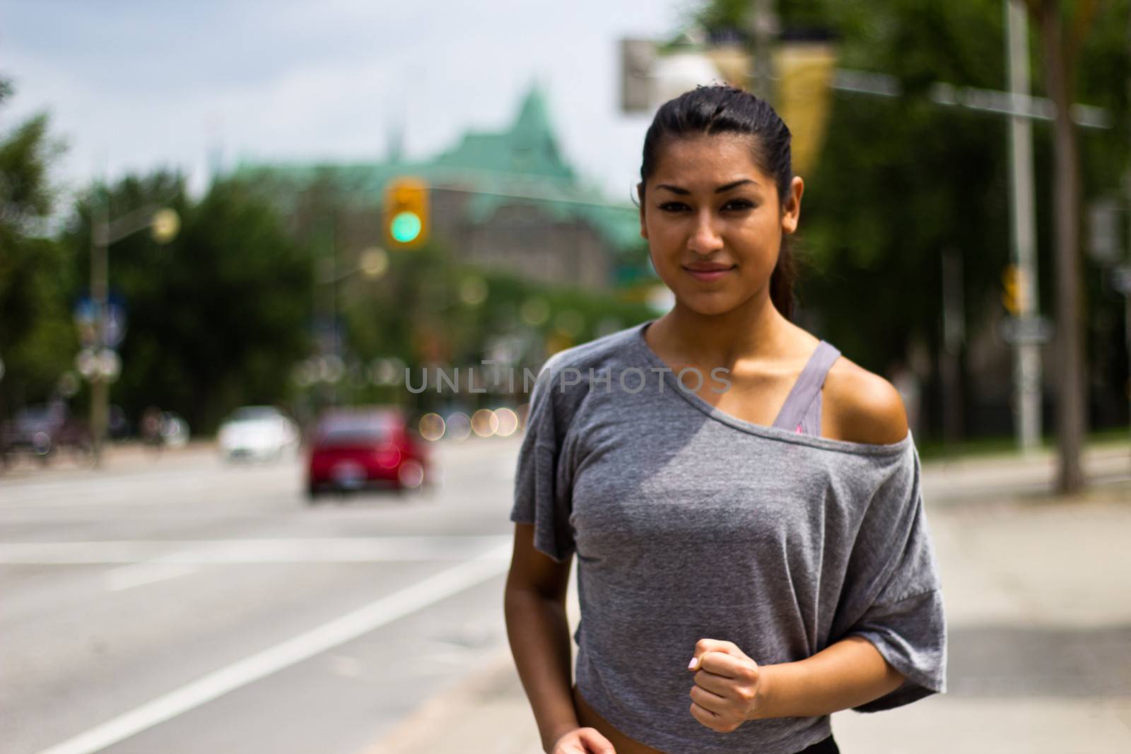 Fit young woman running on a busy city street