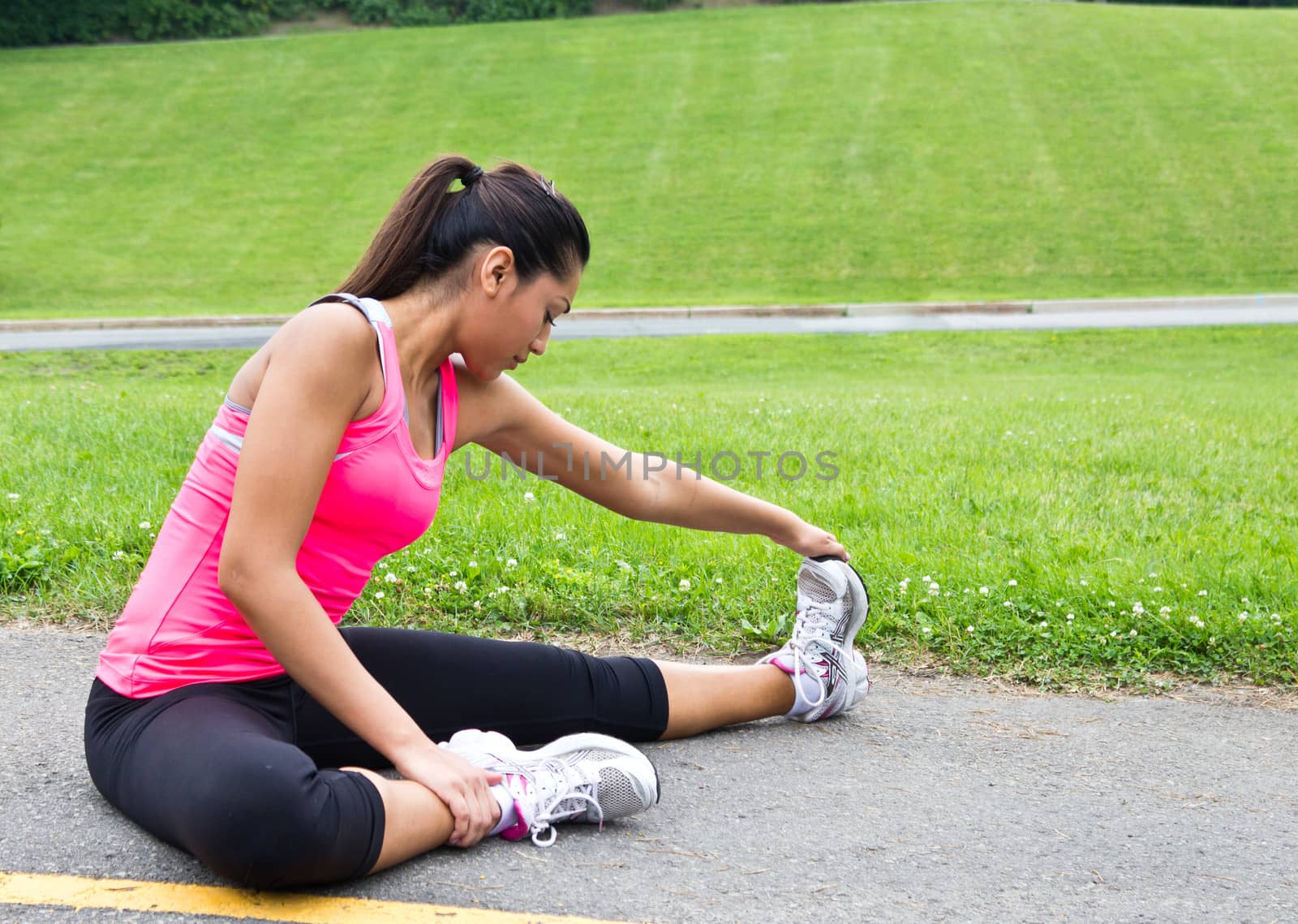 Young woman stretches before running