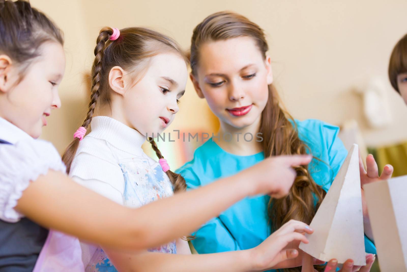 Little children painting and playing at kindergarten