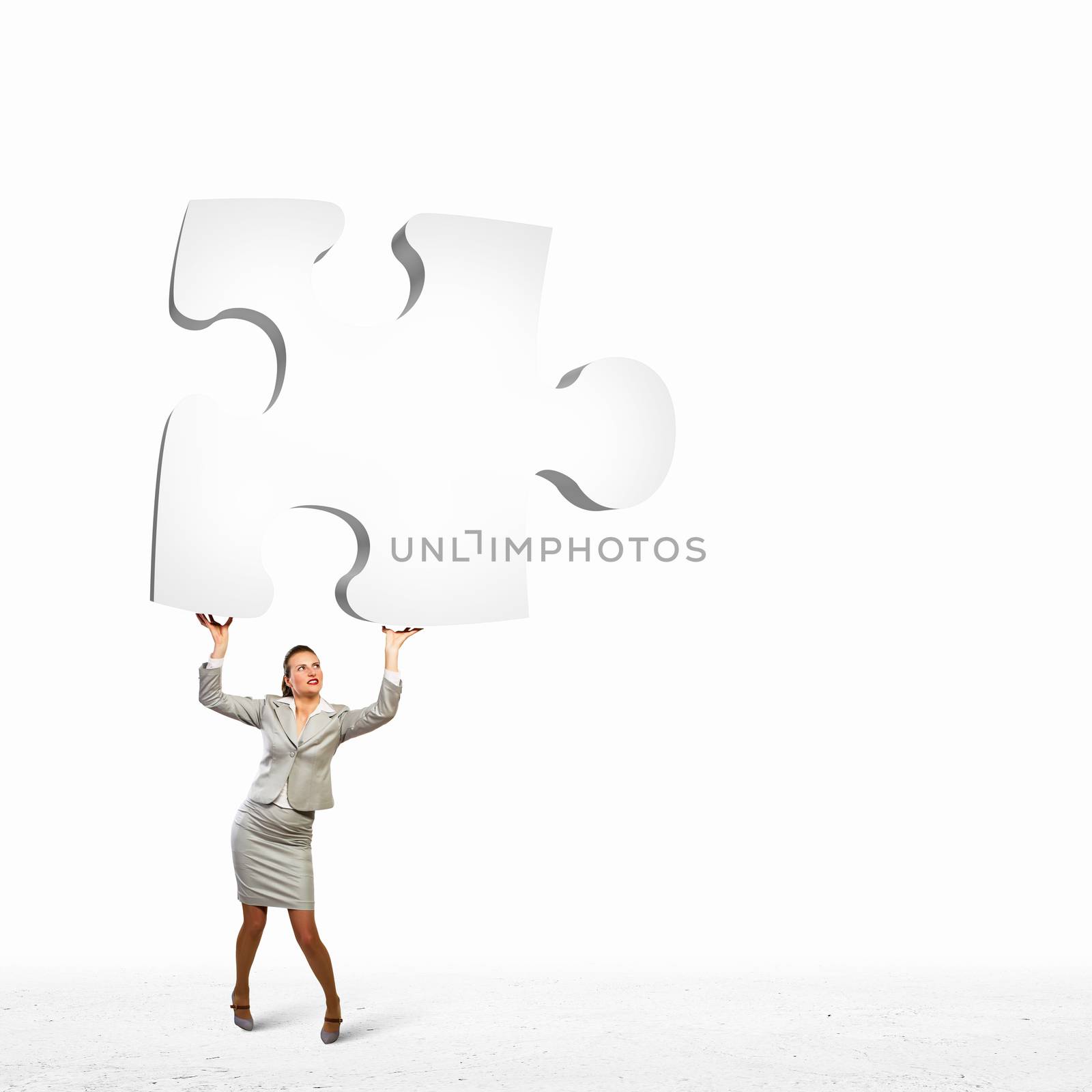 Businesswoman holding puzzle element by sergey_nivens