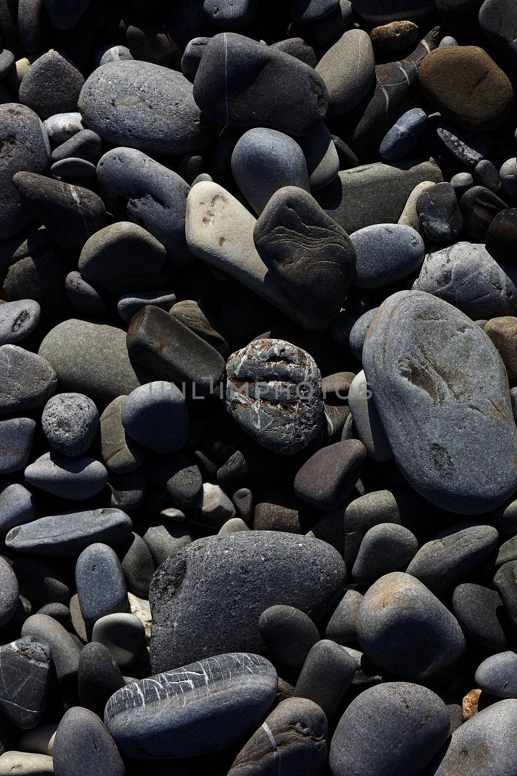 Texture of many gray sea beach pebbles
