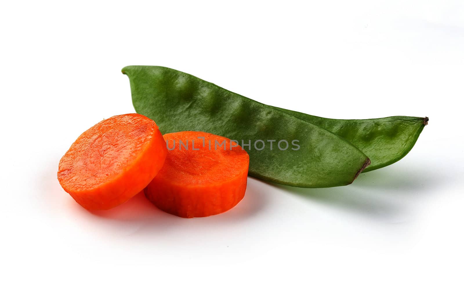Fresh disc of carrot and green peas on the white background