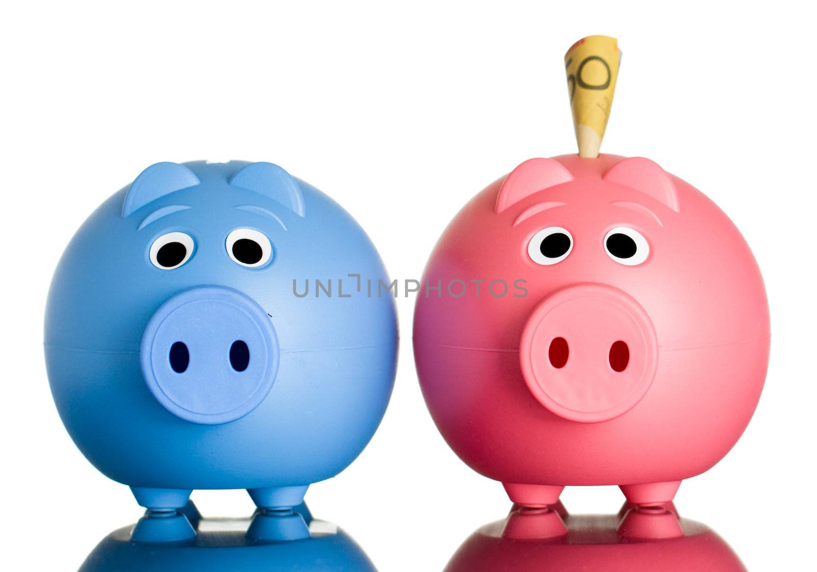 Two cute piggy banks with Australian dollars in one of them. Isolated on white.