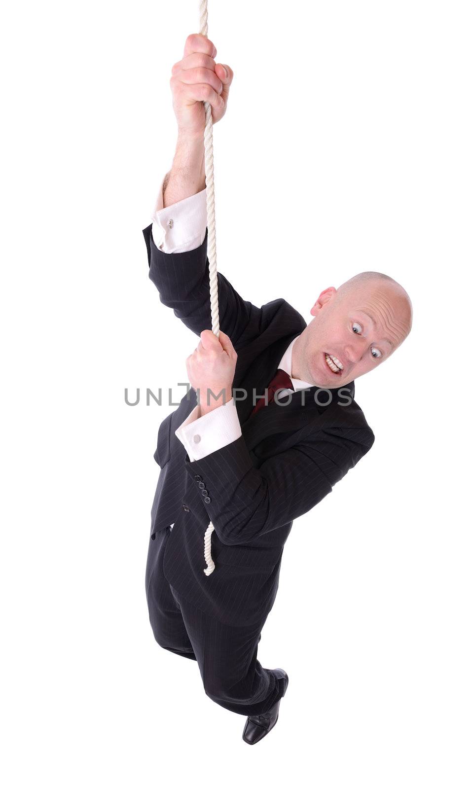 businessman hanging on the end of a rope isolated on white background