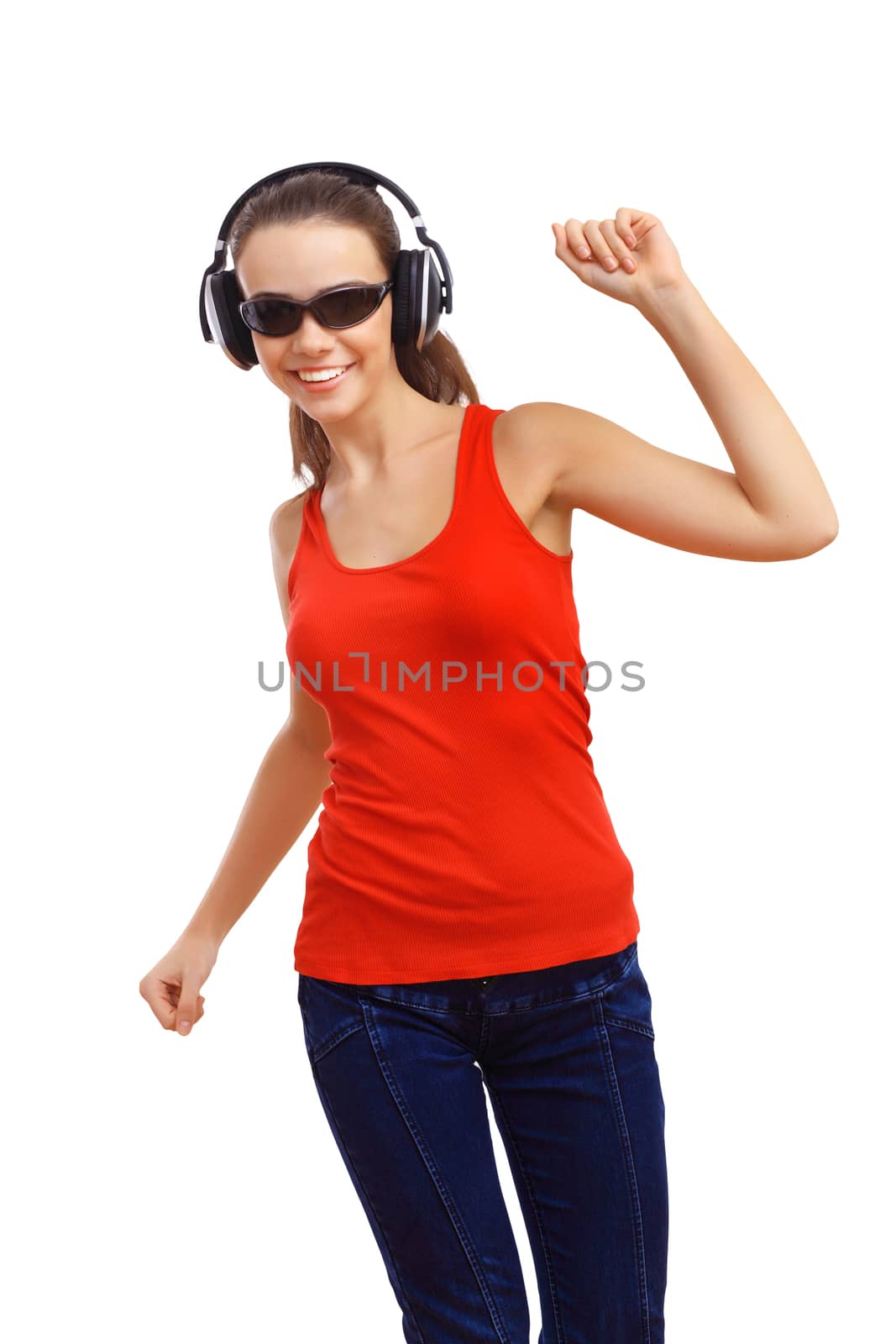 Happy smiling girl dancing and listening to music