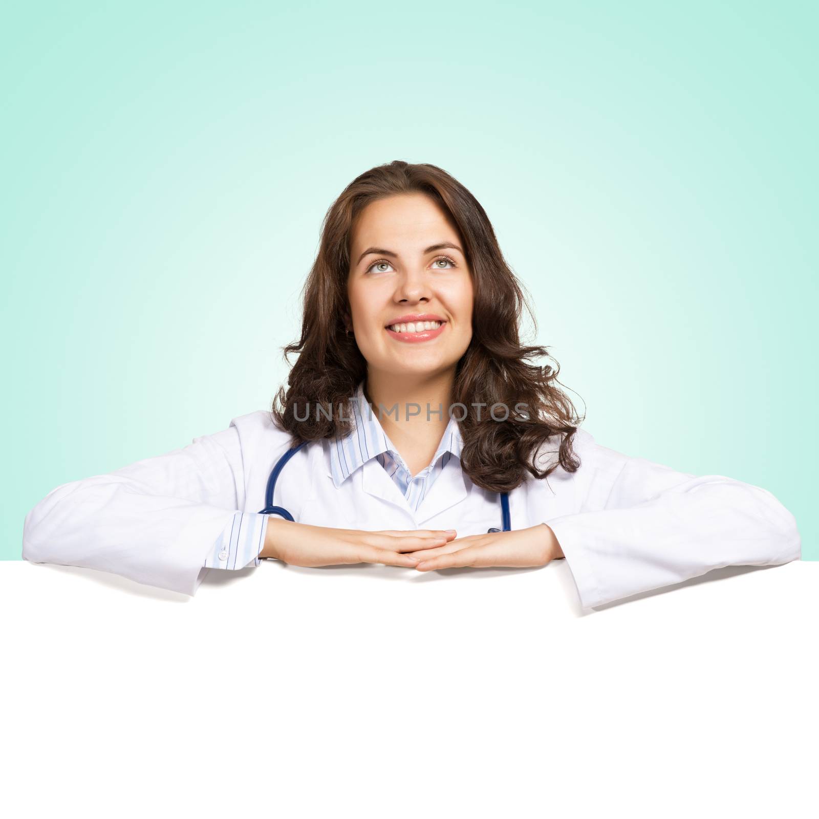 Young attractive female doctor put her hands on the blank banner, place for text