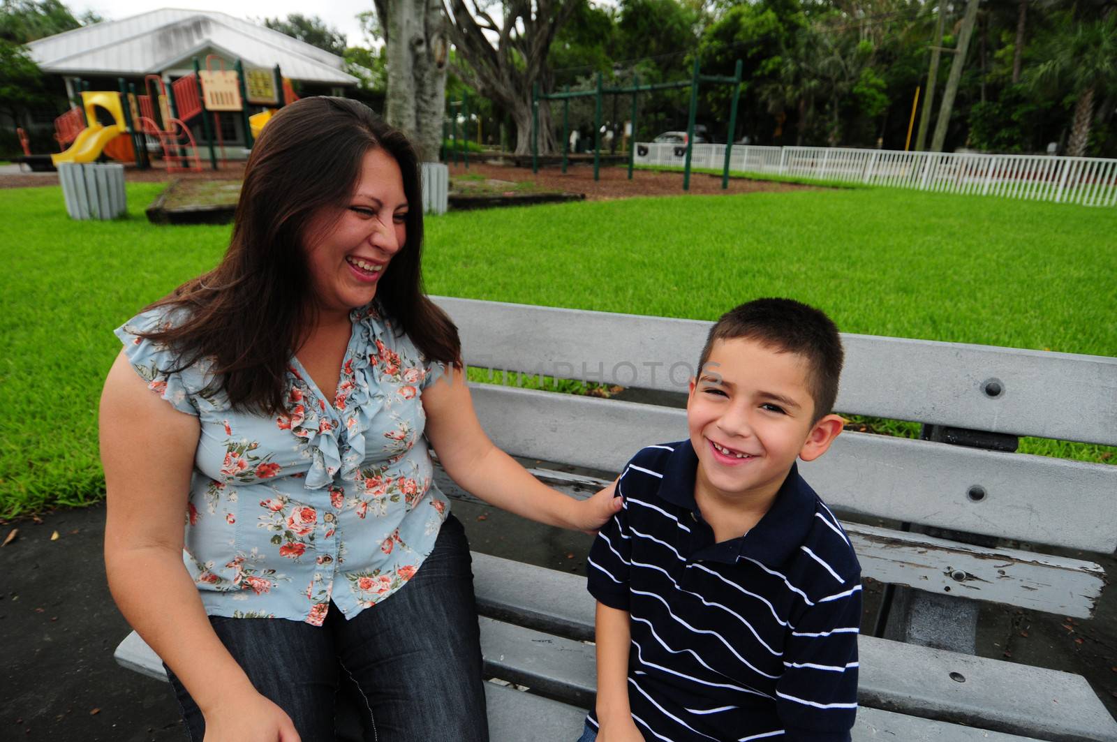 mother and son laughing while at park