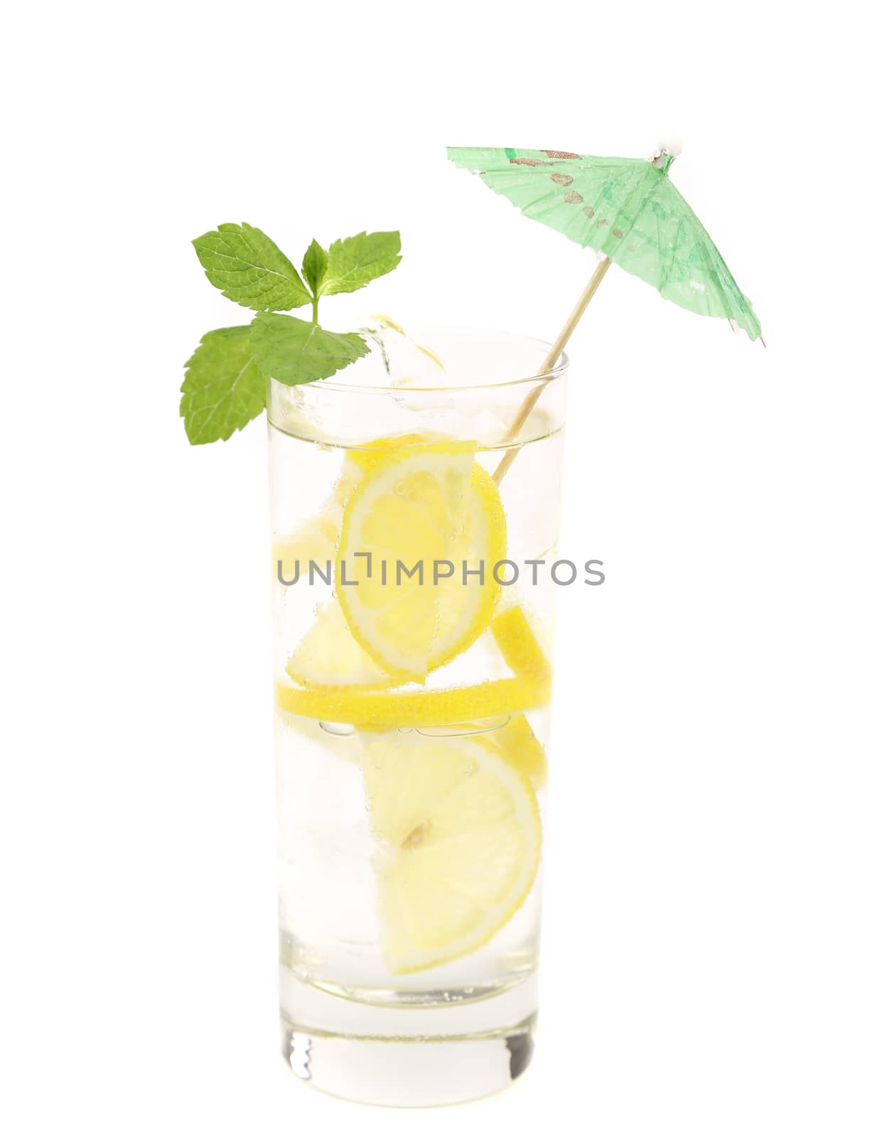 Full glass of water with lemon and mint. Close up. White background.