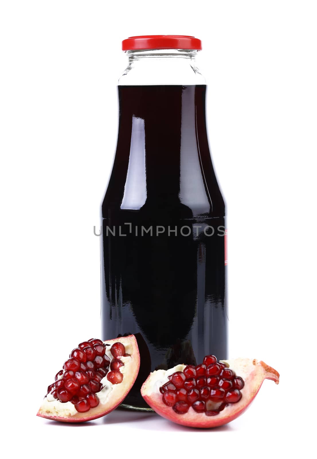 Juice and slices pomegranate on white background. Close up.