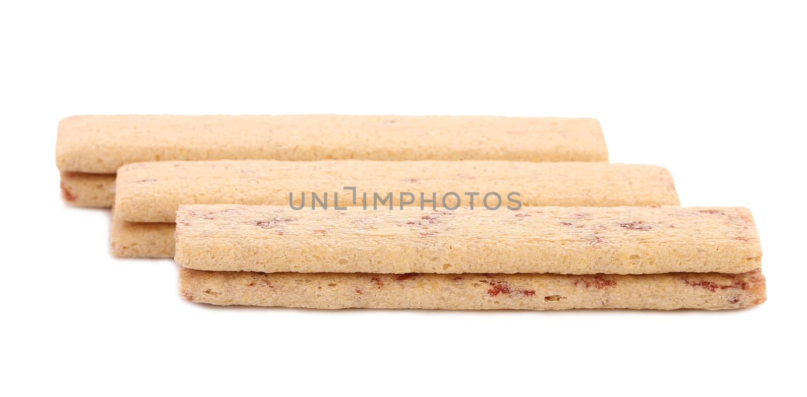 Sticks of biscuit with filling. White background.