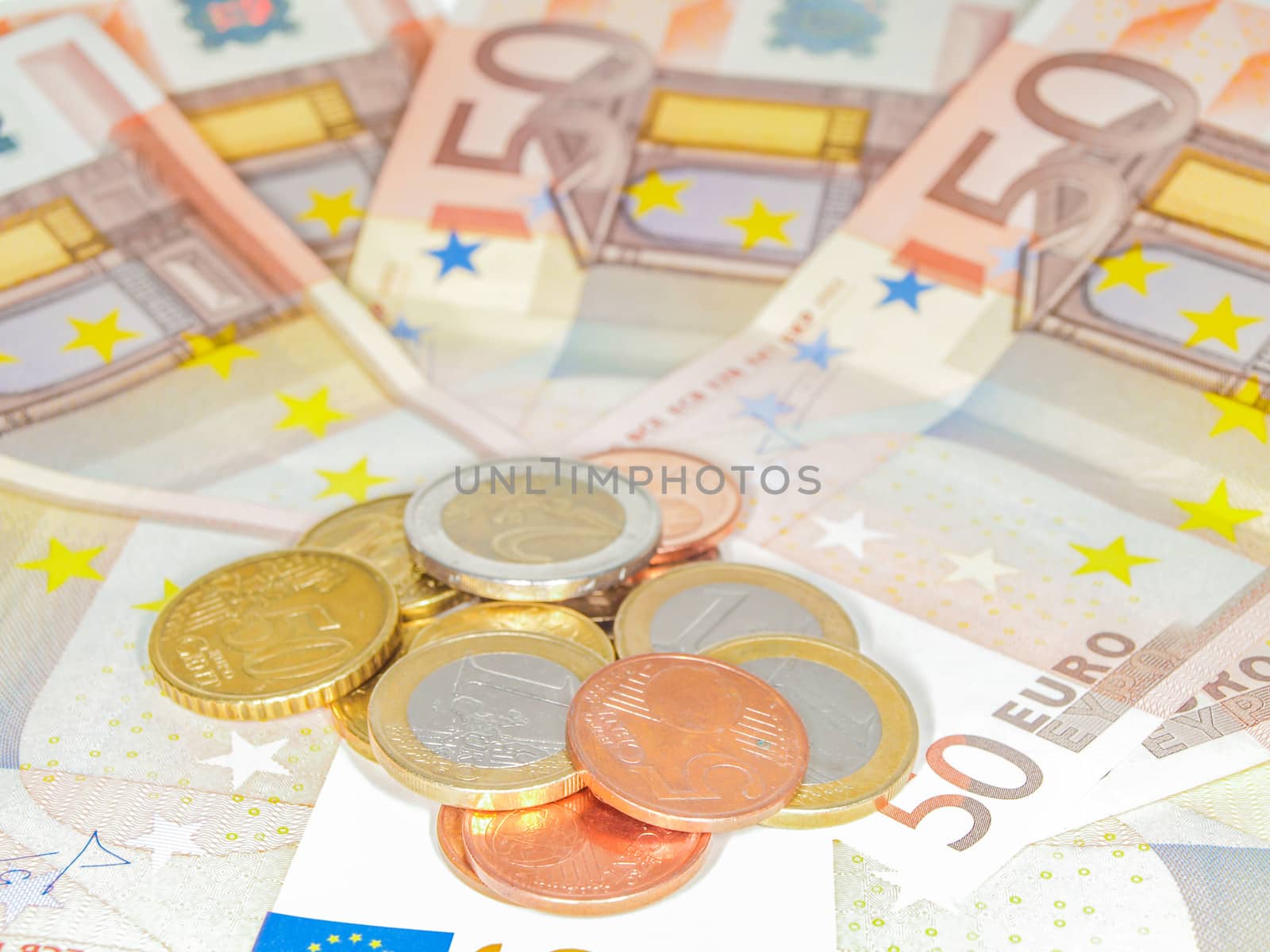 Coins over 50 Euro bills by Arvebettum