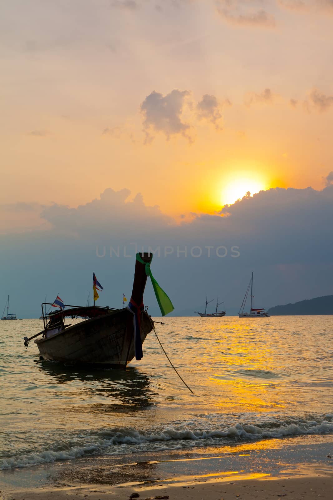 Longtail boats against a sunset. Ao-Nang, Thailand. by elena_shchipkova