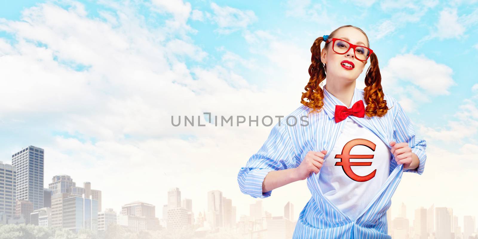 Young woman acting like super hero with euro sign on chest