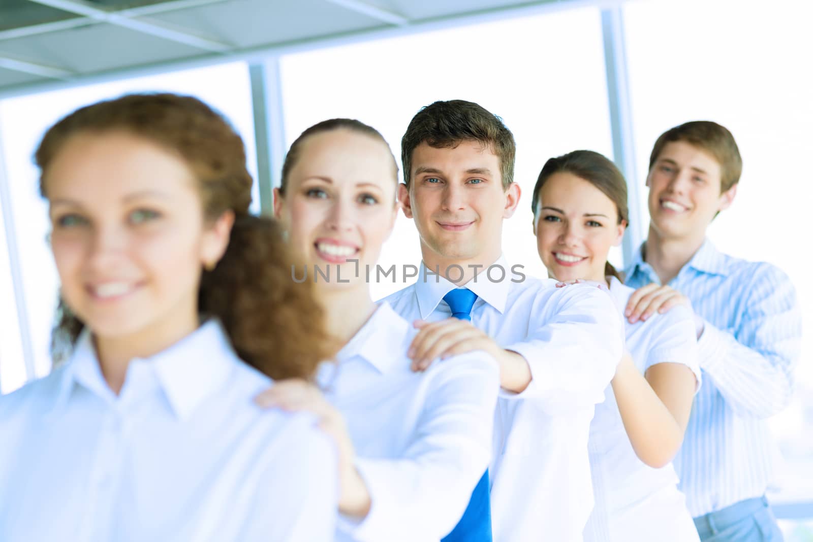 portrait of a young businessman standing in a row with his colleagues, concept of teamwork