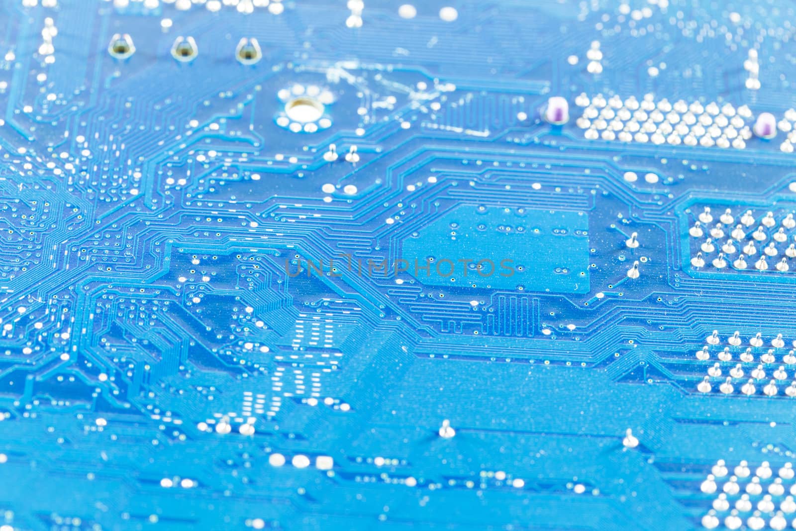 close up of the blue circuit board  by thanomphong