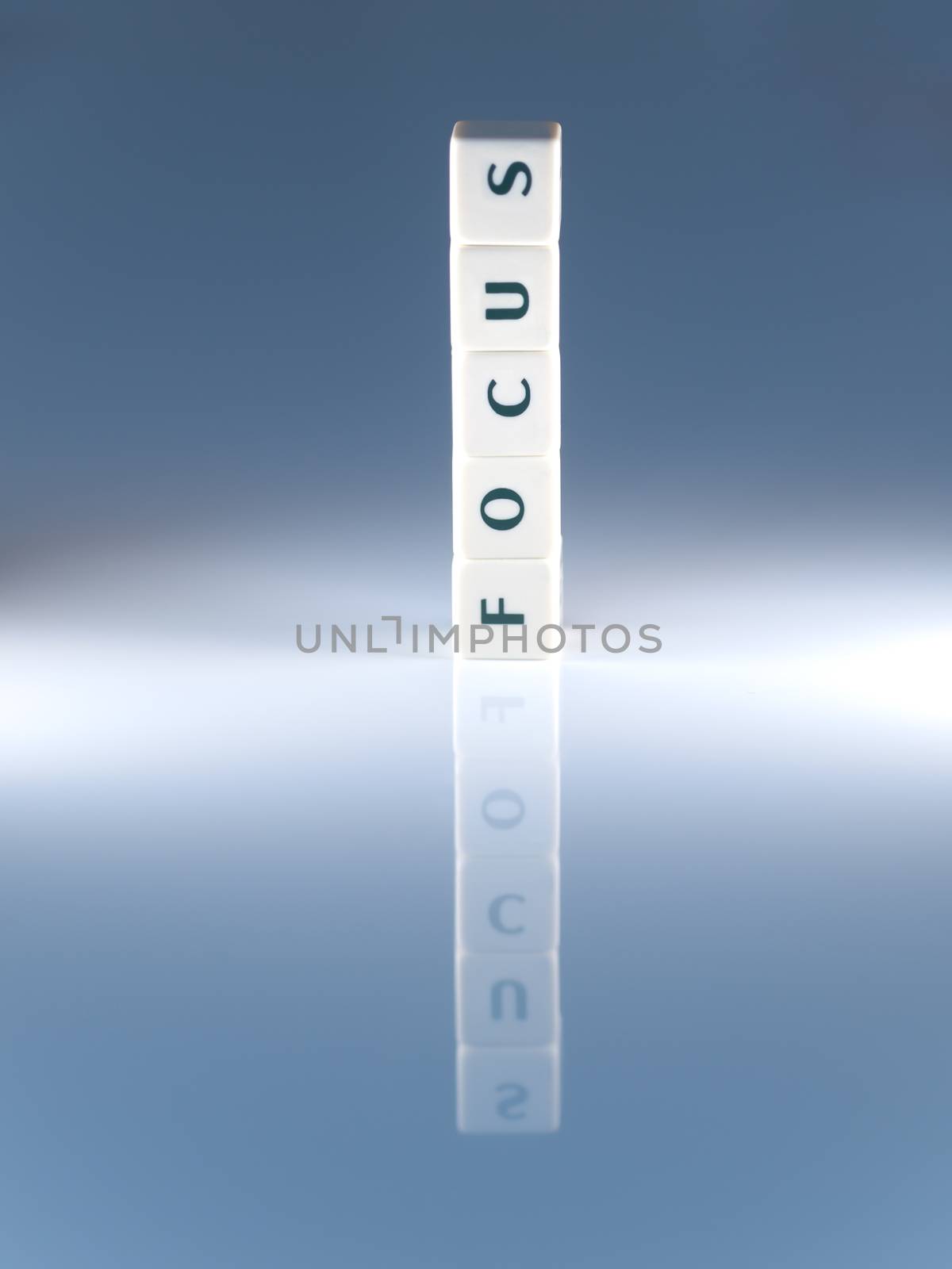 Focus word concept made of scrabble pieces with reflection for business concept