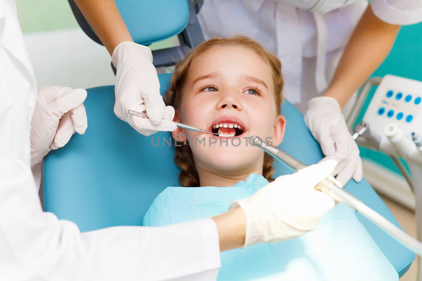 Little girl sitting in the dentists office