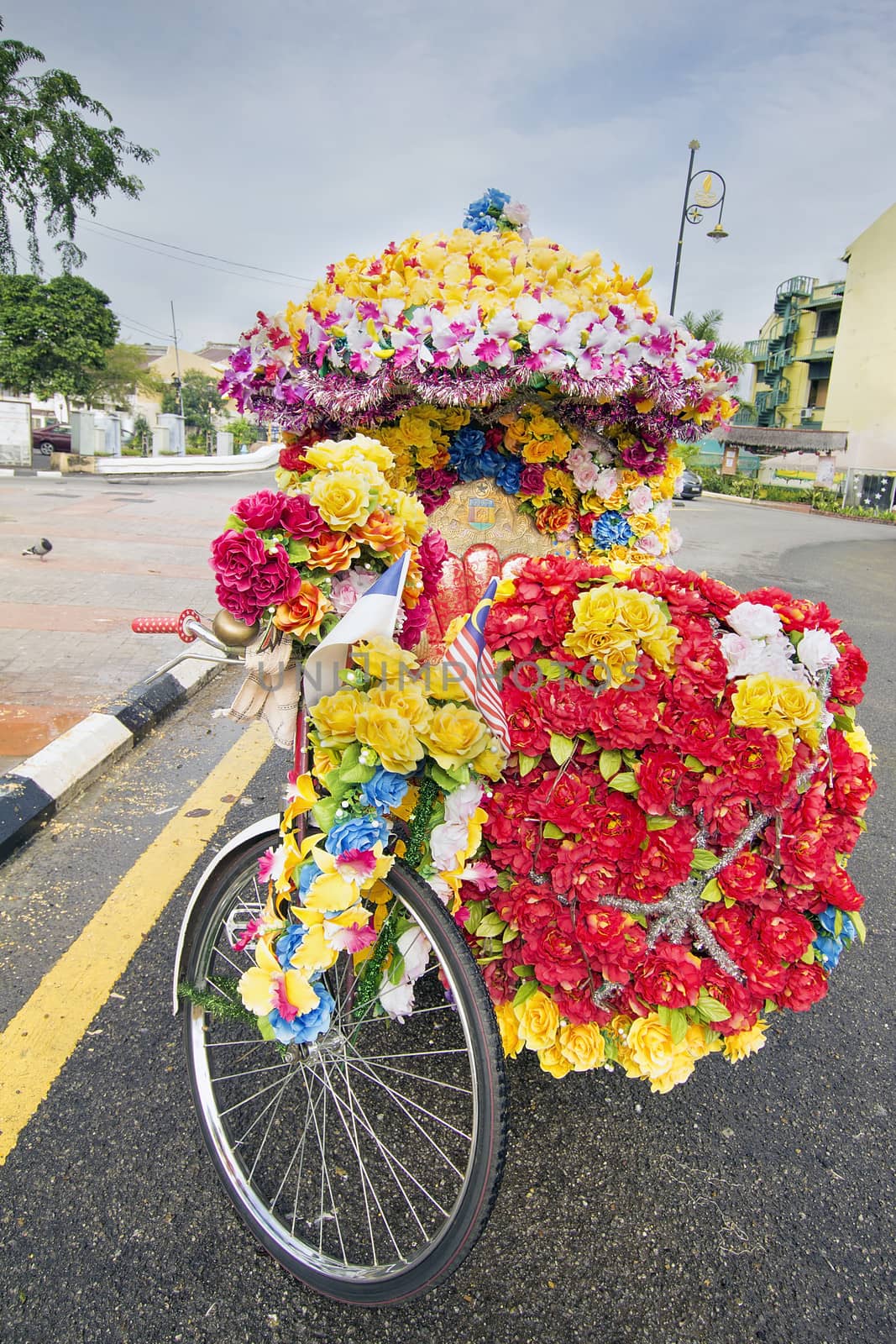 Trishaw Decorated with Colorful Silk Flowers Parked on Roadside in the Port Town of Malacca Malaysia