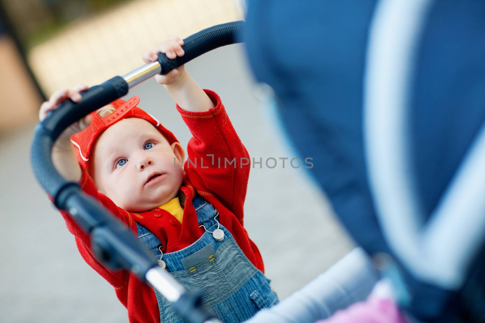 little child with a baby carriage
