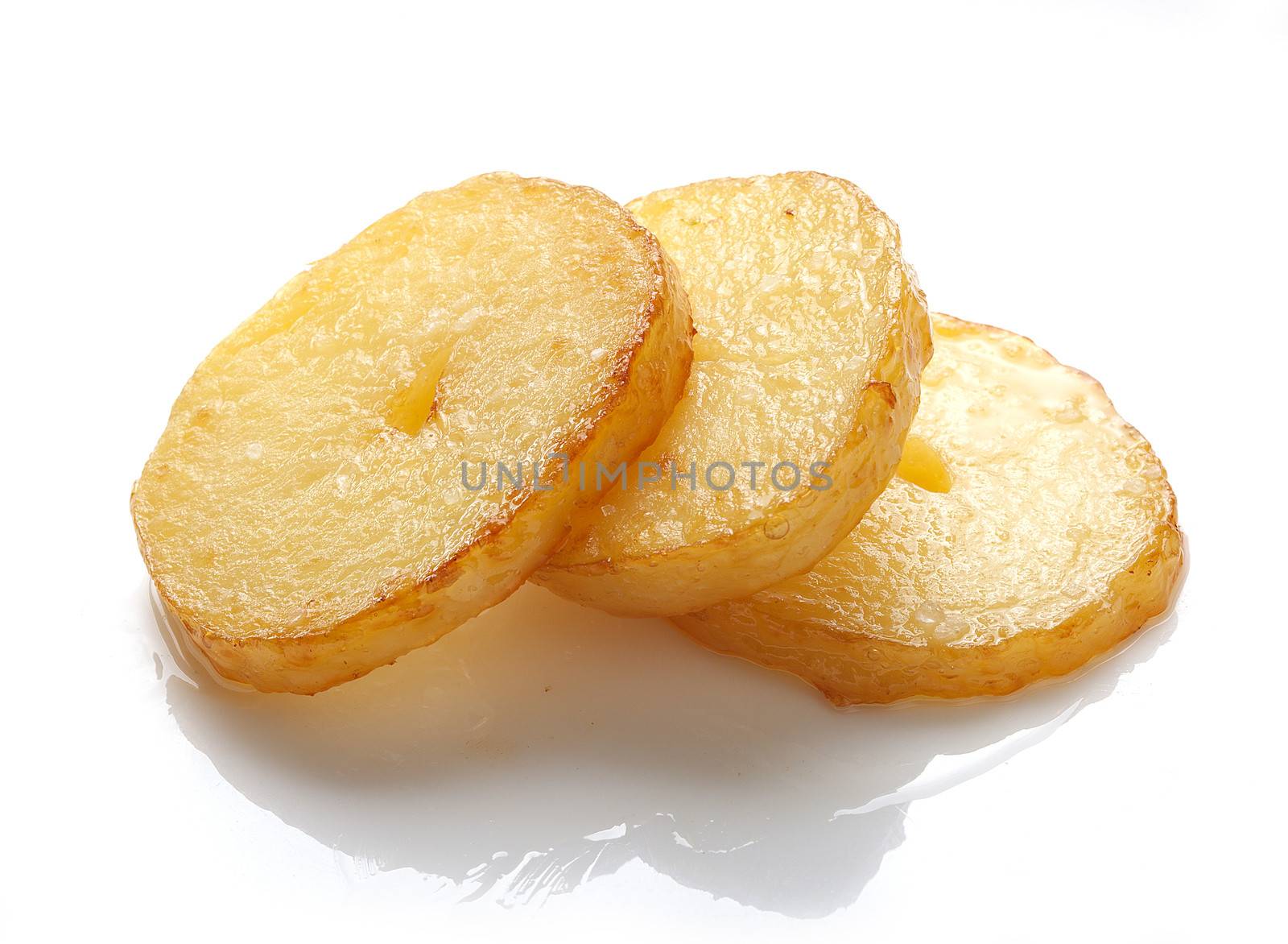 Three isolated fried pieces of potato on the white background