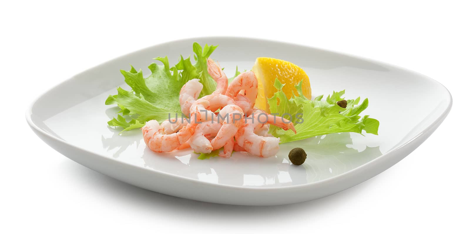 Cleanesed shrimp's tails with fresh lettuce and lemon on the white plate