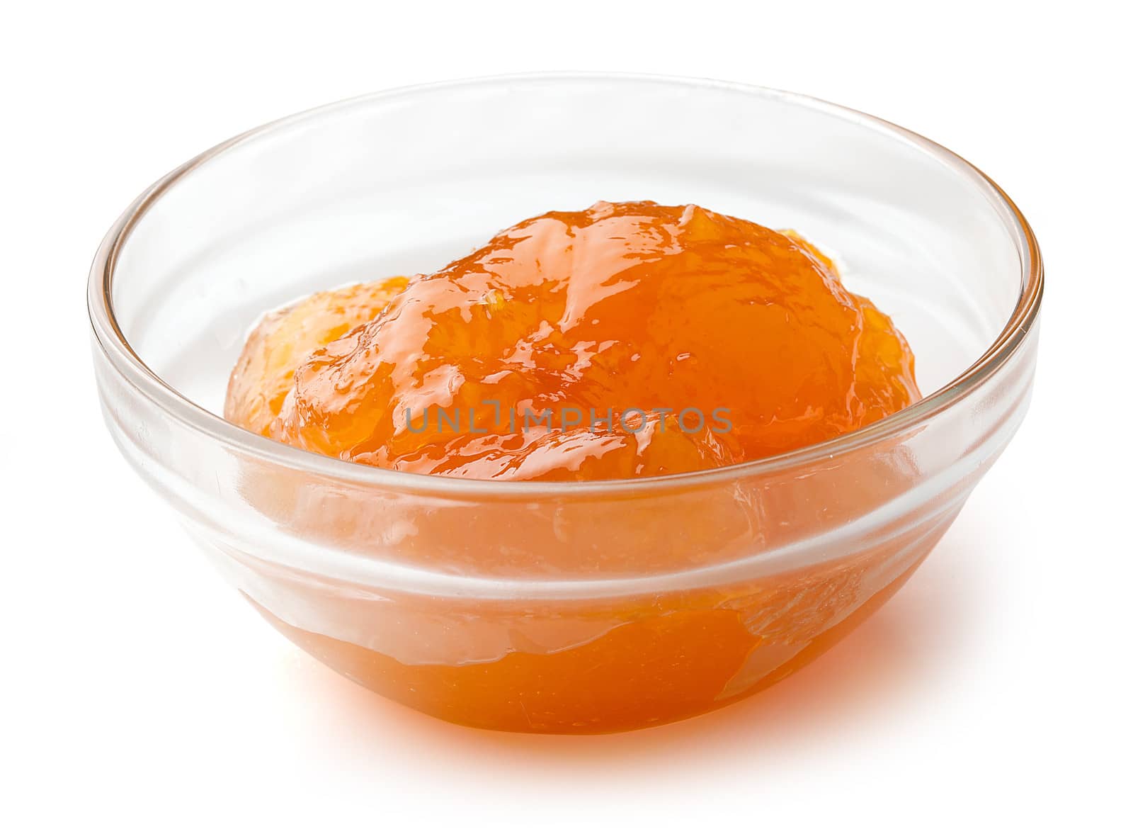Apricot's jam in the glass bowl on the white