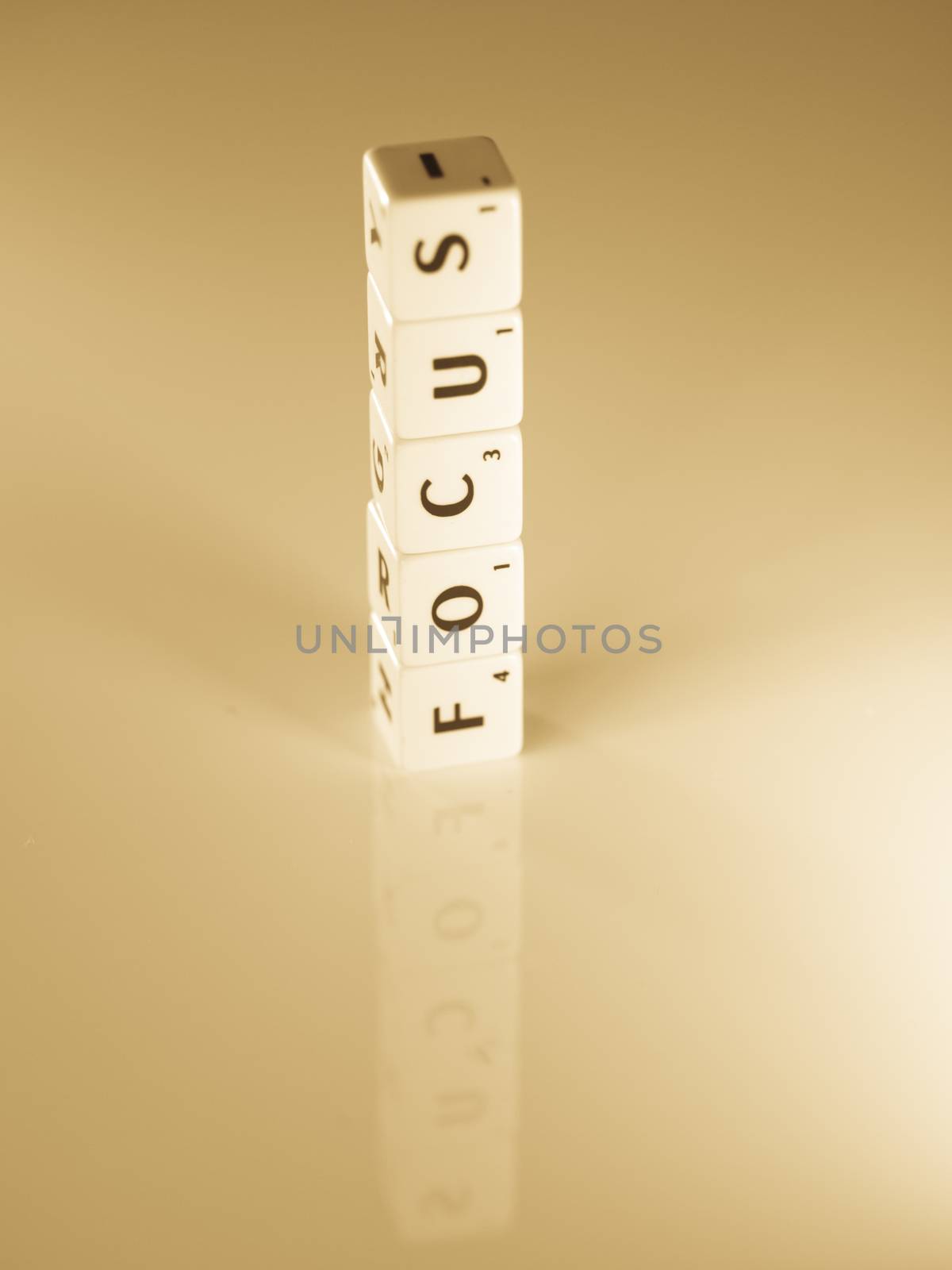 Focus word concept made of scrabble pieces with reflection for business concept