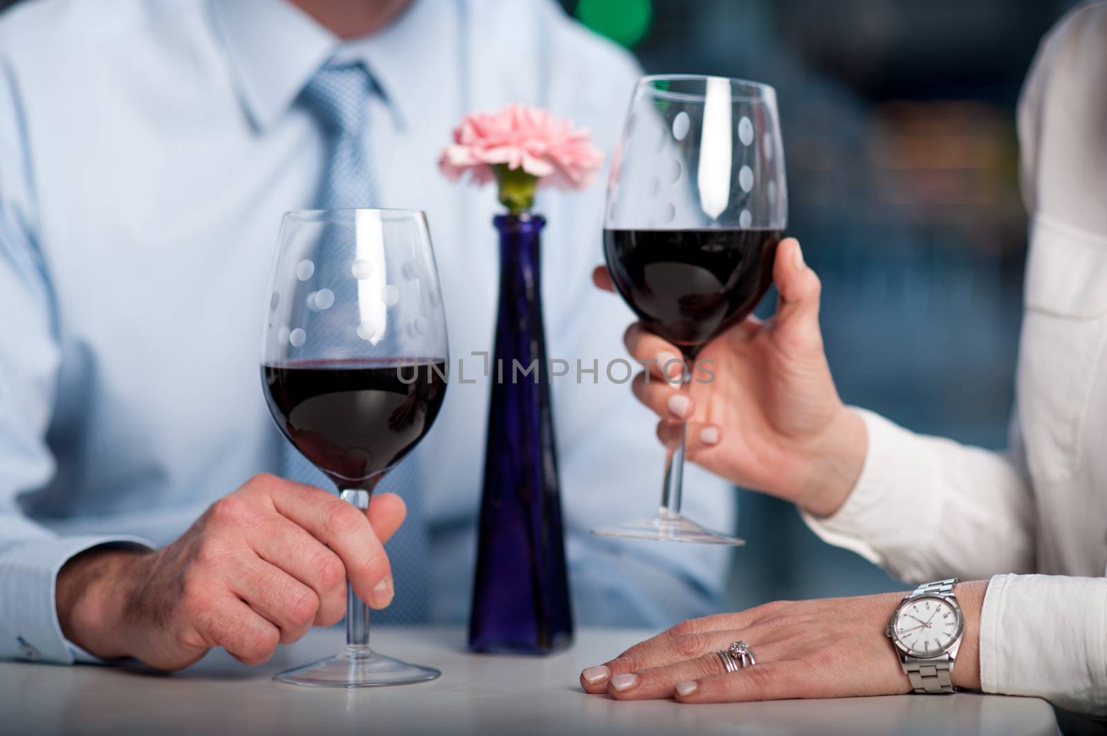Business people enjoying wine, cropped image by stockyimages