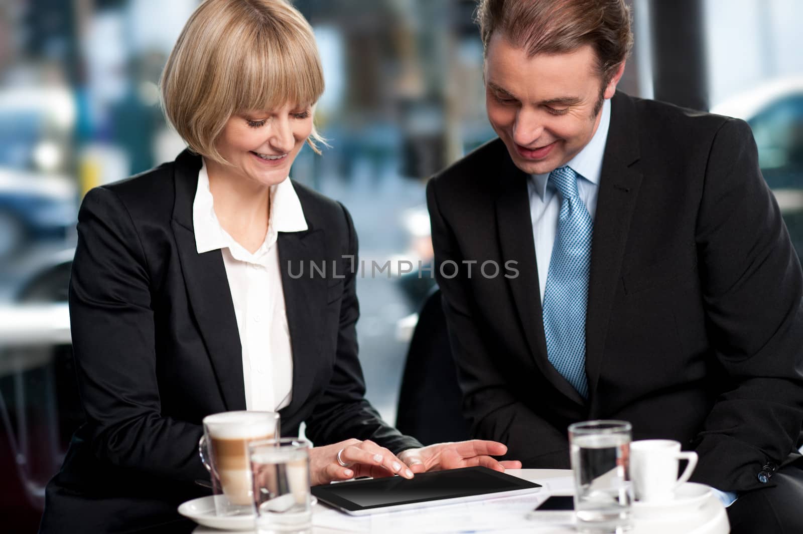 Corporates discussing business over a coffee by stockyimages