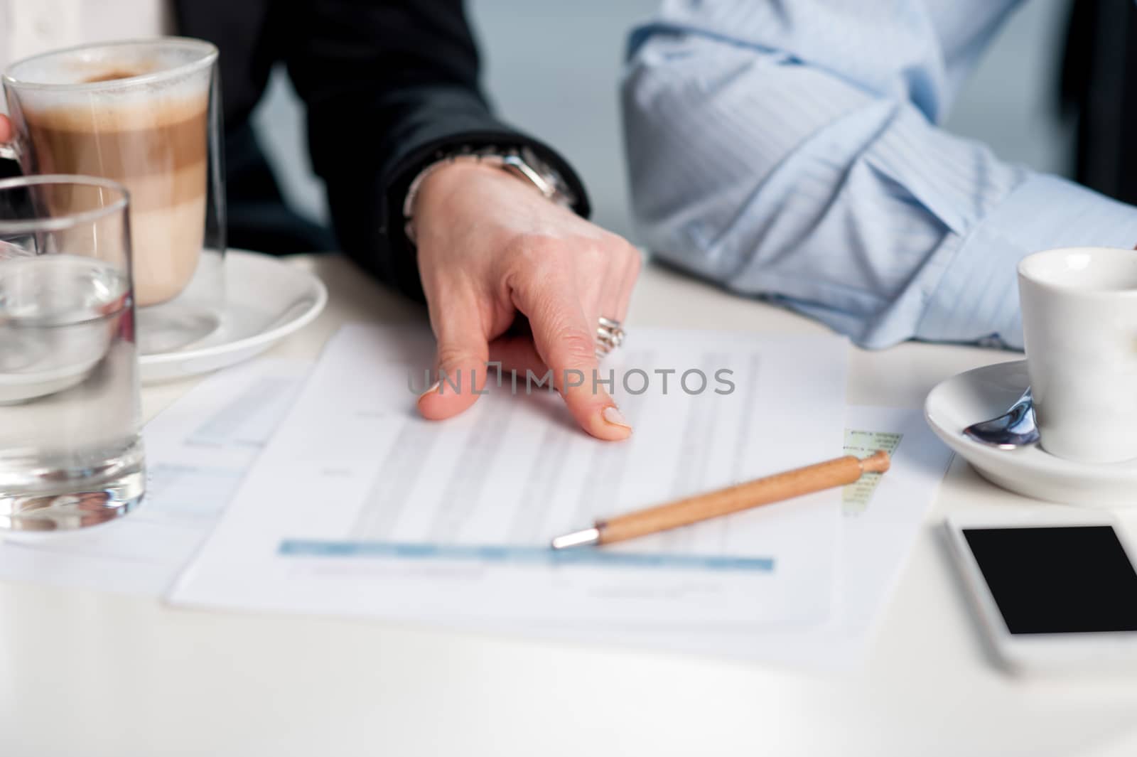 Business people discussing monthly statistics by stockyimages